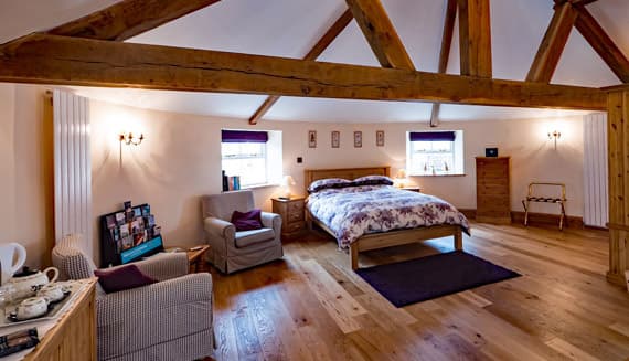 Content Bedroom with wooden beamwork