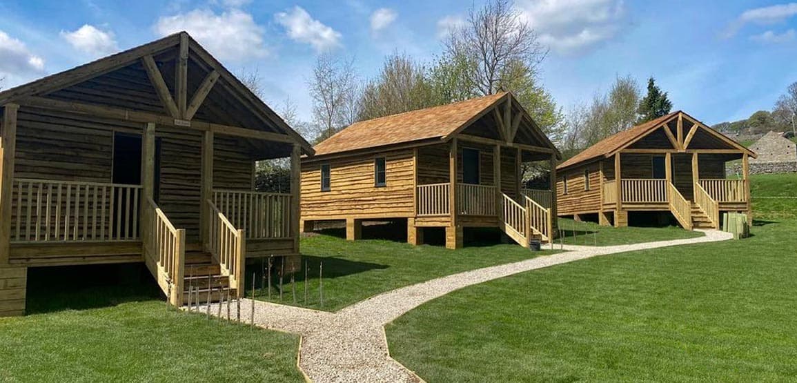 How Stean Gorge exterior view of rustic wooden lodges Yorkshire Dales with Hot Tubs